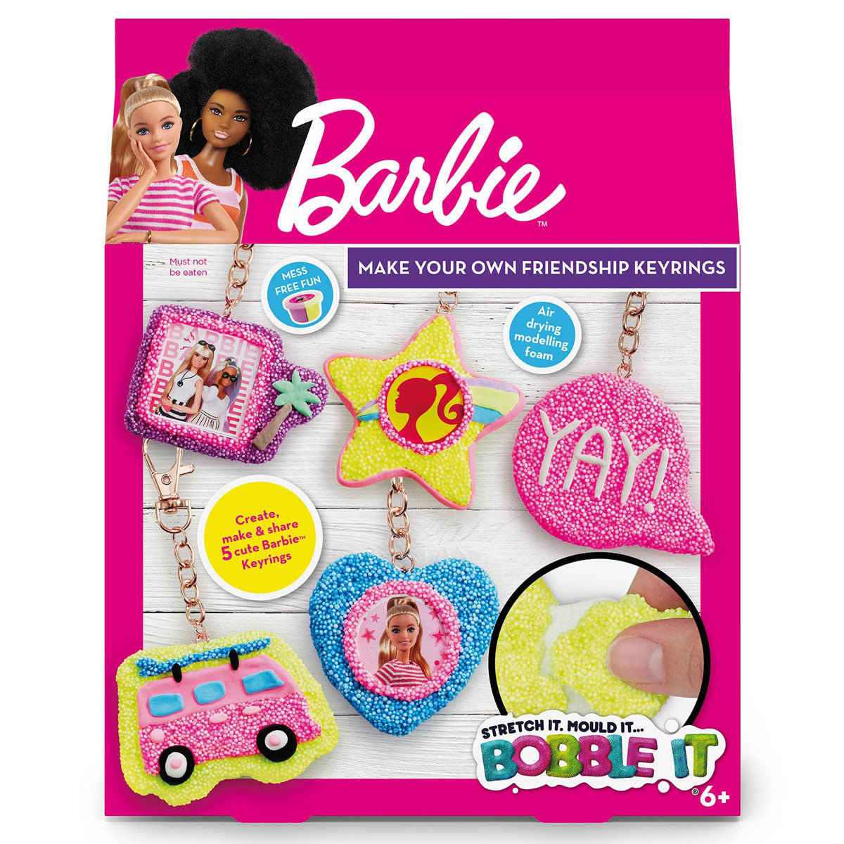 Barbie make your own friendship keyrings kit packaging with colorful keyrings and dolls on a pink background.